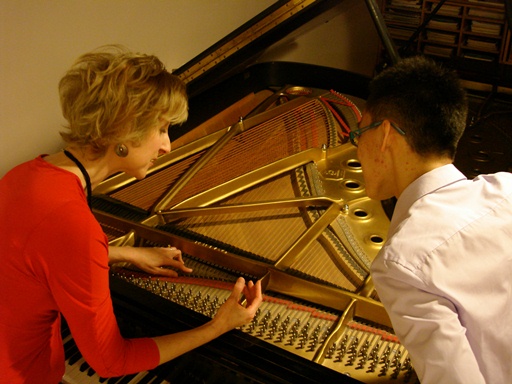 Jacqueline explaining the nner workings of the piano to a student